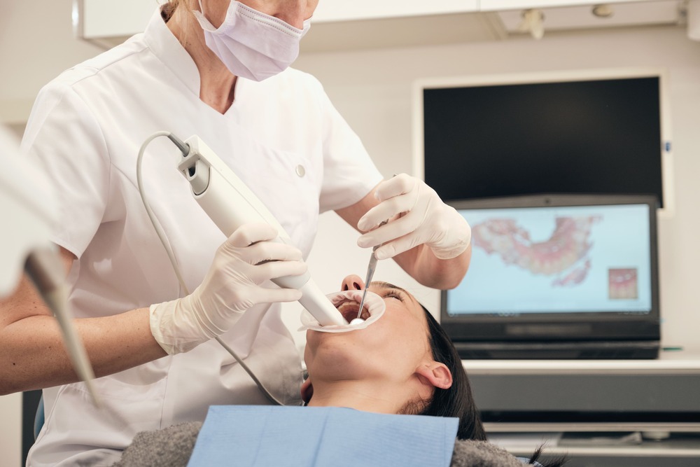 female dentist scanning teeth of woman 2022 03 04 05 56 00 utc