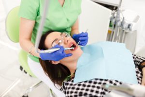 young beautiful woman treats teeth at the dentist 2022 02 02 02 02 50 utc