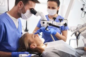 male dentist working with dental microscope 2023 11 27 05 32 45 utc 1